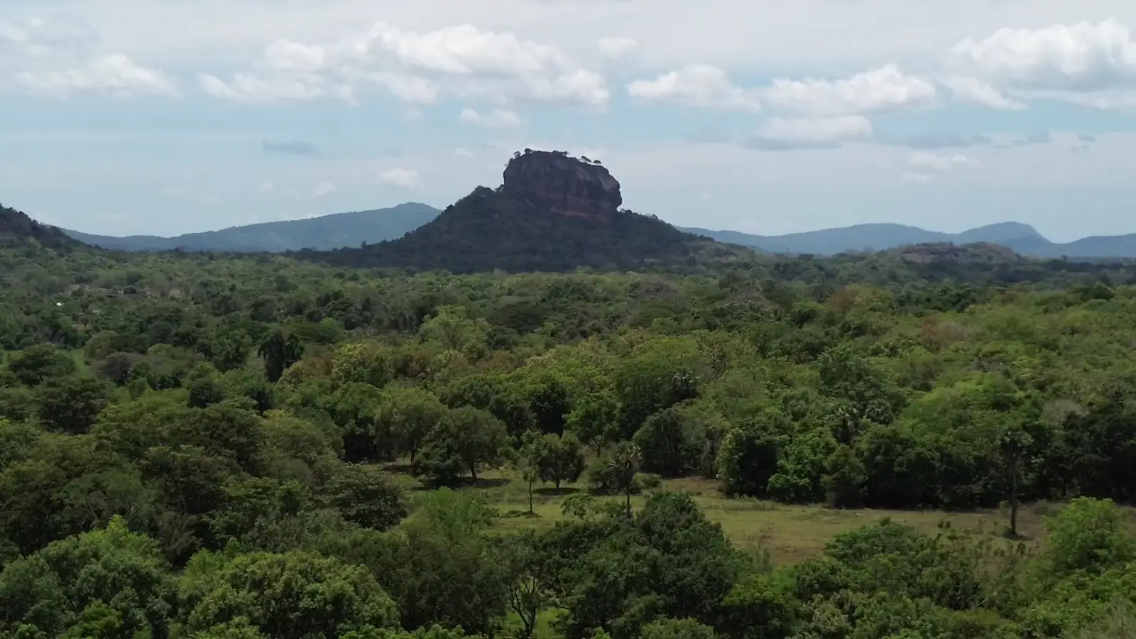 Aerial view of Sigiriya rock fortress rising above the jungle canopy